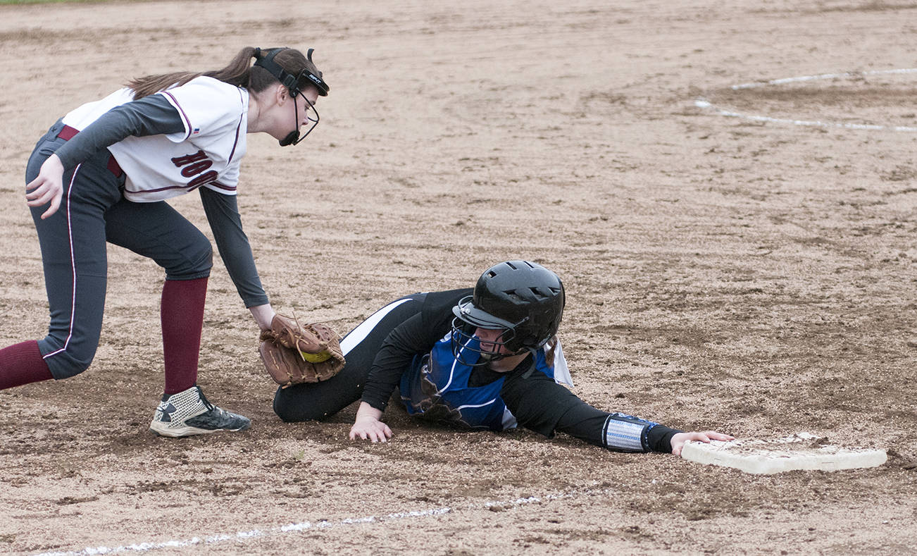 (Brendan Carl | Grays Harbor Newspaper Group)                                Elma’s Peyton Elliott gets her hand on third base just before the tag of Hoquiam’s Jade Cox during an Evergreen 1A League game at Gable Park on Tuesday.