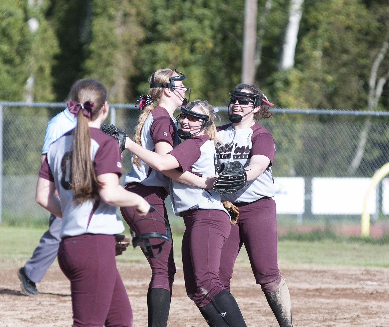 (Brendan Carl | Grays Harbor Newspaper Group) Montesano’s Samantha Stanfield, left, Morgan Kersker, center, and Allyssa Gustafson celebrate after the Bulldogs defeated Elma 3-1 on Wednesday.