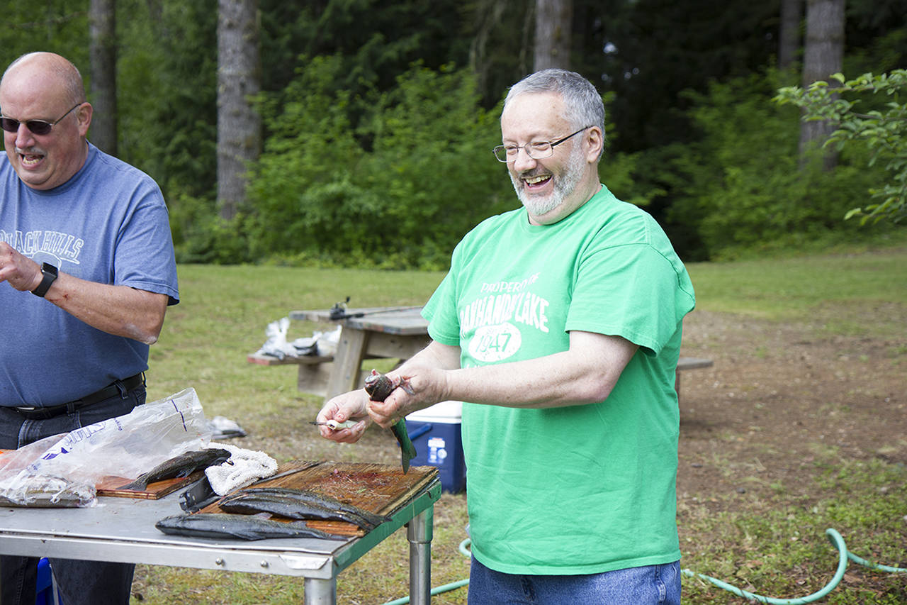 (Corey Morris | The Vidette) Montesano 4-H leader Jeff Wetzel cleans a trout during the annual kids fishing derby on June 4 at Panhandle Lake 4-H Camp.