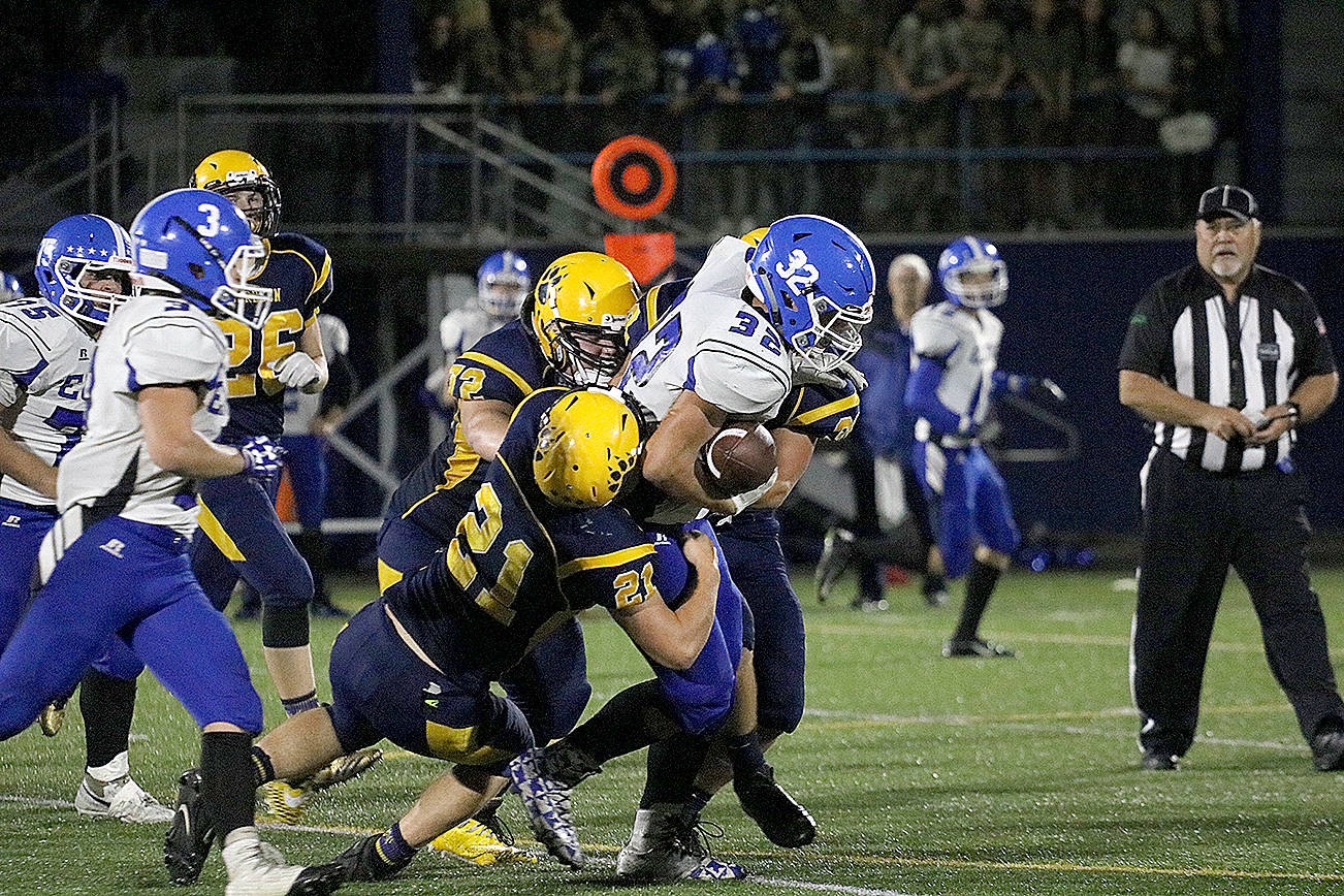 (Travis Rains | Grays Harbor Newspaper Group) Elma’s Taitum Brumfield manages to hang onto the ball while Aberdeen goes for the strip during a game on Sept. 15 at Aberdeen.