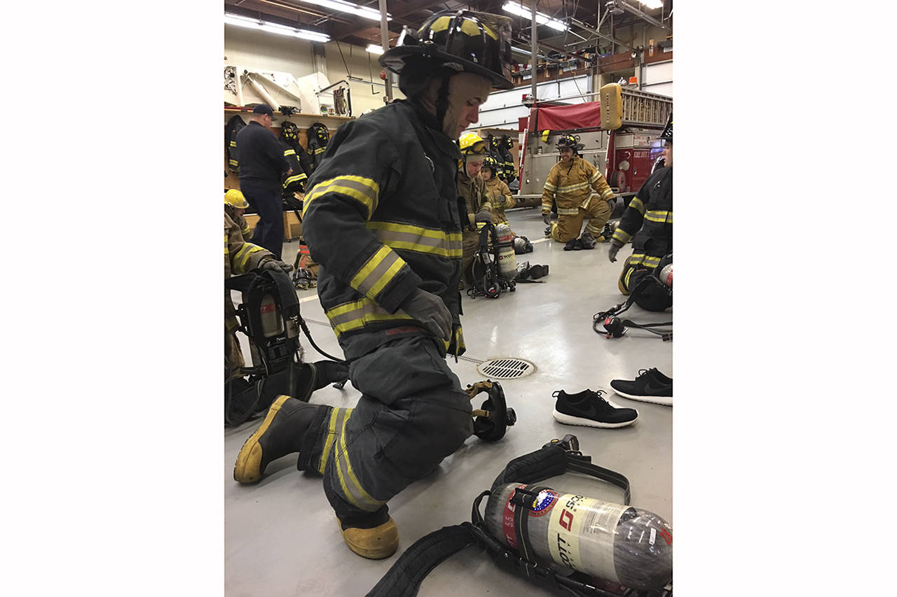 (Todd Bennington | The Vidette)                                Montesano senior Connor Parkinson participates in drills during a fire cadet program at the Montesano Fire Department on Dec. 2.