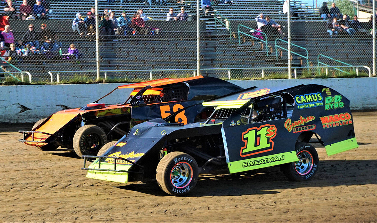 Photo by AR Racing Videos                                 Tom Sweatman (11) battles for position with David Wolfard during the Modifieds feature race on Saturday at Grays Harbor Raceway in Elma.