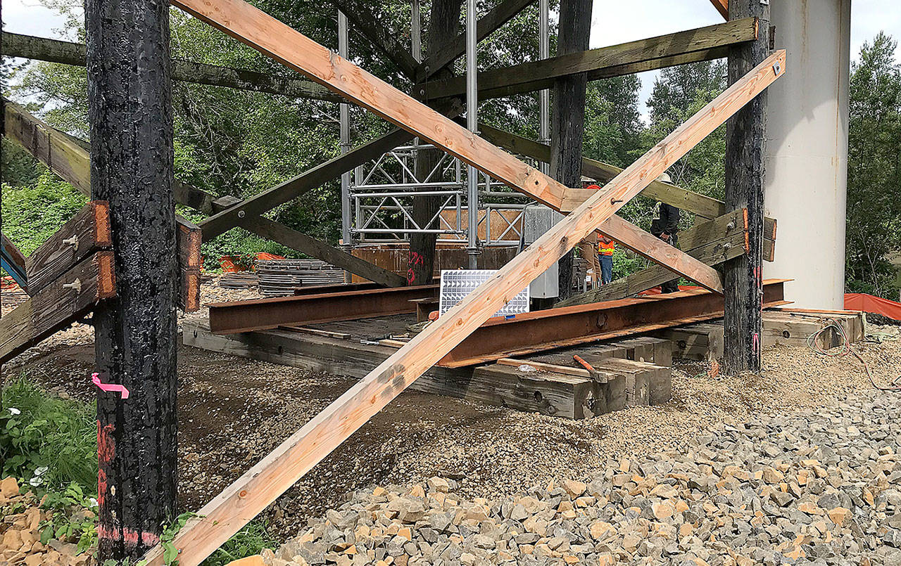 COURTESY DEPARTMENT OF TRANSPORTATION                                Crews from Rognlin’s Inc. shore up the State Route 107 Chehalis River bridge south of Montesano. The roadway, closed Tuesday morning after construction crews found the timber bridge support pilings on the south approach had settled up to six inches, is on track to reopen at 8 a.m. Friday.