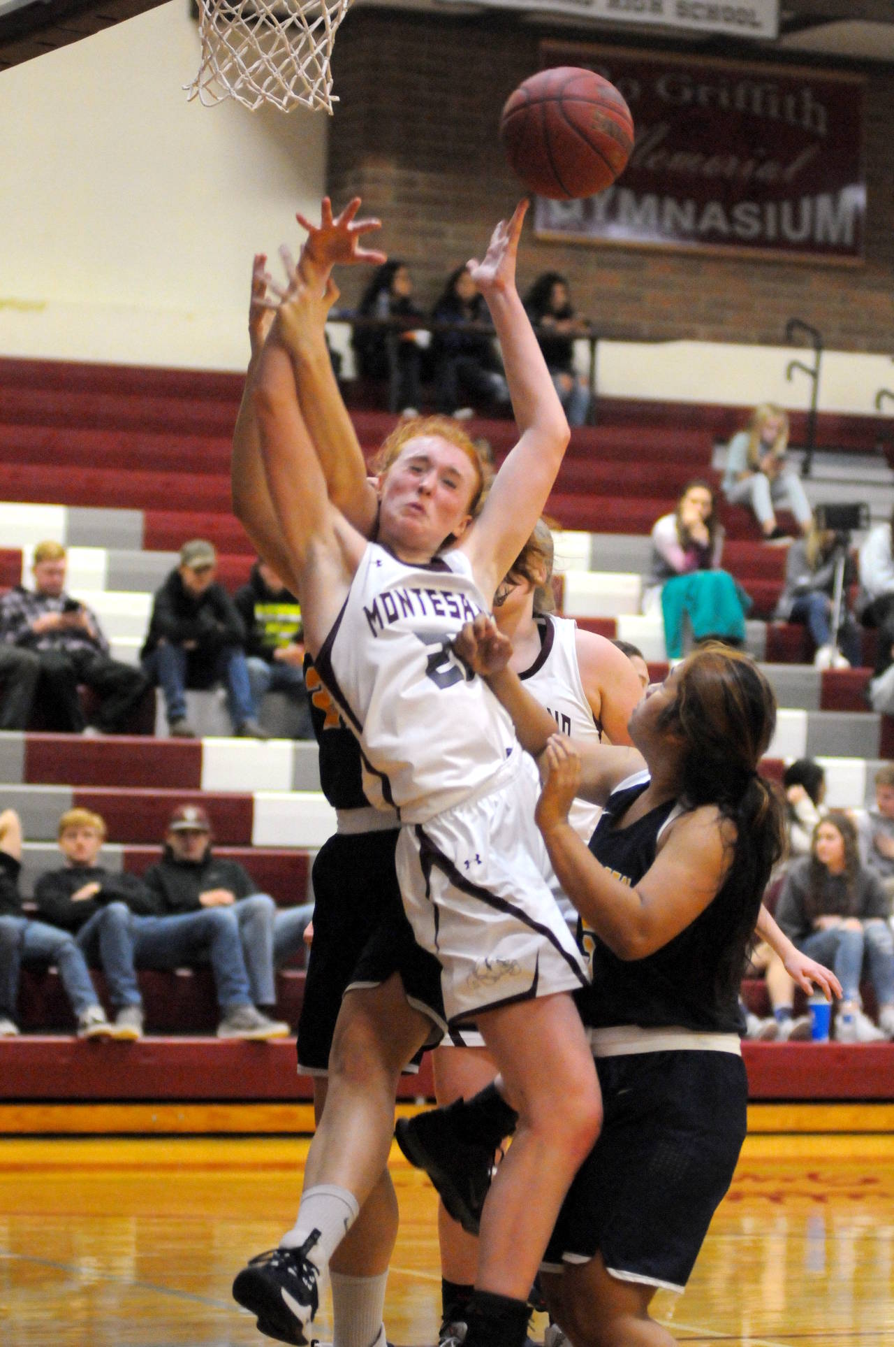 Montesano’s Zoee Lisherness takes a hard hit on a play at the basket during Monte’s 64-35 victory over Aberdeen on Tuesday in Montesano. (Ryan Sparks | Grays Harbor News Group)