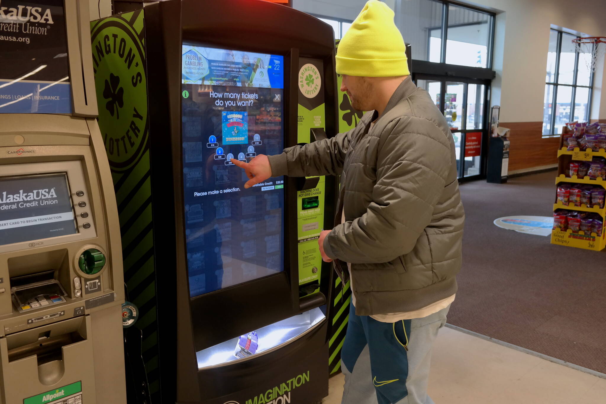 Aberdeen resident Landon Morse purchases a lottery ticket at the Safeway on Heron Street Monday, March 14. Erika Gebhardt I The Daily World